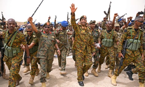 Sudanese army chief Abdel Fattah al-Burhan and troops with their arms raised