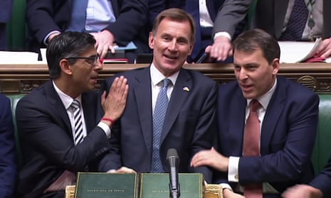 Jeremy Hunt is congratulated by Rishi Sunak, left, and John Glen after his autumn statement