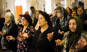 Women attend Maundy Thursday mass at Mar Hanna (St John’s) church in Hamdaniya.
