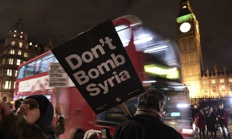 A protester holds a placard reading ‘Don’t attack Syria’ outside parliament on the eve of the Commons vote. 