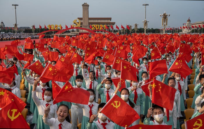 Chinese students who were to sing as a choir wave party and national flags at a ceremony marking the 100th anniversary of the Communist Party