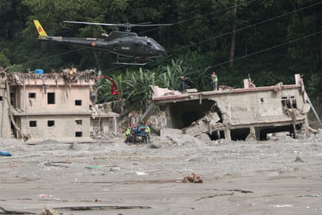 Nepali security personnel and rescue teams conduct search and rescue operations in flood-hit areas of Rasuwa