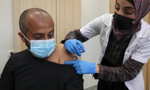 A healthcare worker administers a shot of the Pfizer-BioNtech Covid-19 vaccine to a man at a clinic in the Negev’s main Bedouin town of Rahat. Residents of villages deemed illegal by Israel say more houses have been demolished than people vaccinated, despite the Jewish state’s world-beating coronavirus inoculation drive.
