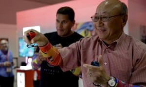 Nintendo global president Tatsumi Kimishima (R) and Nintendo of America president Reggie Fils-Aime play Arms at E3 2017.