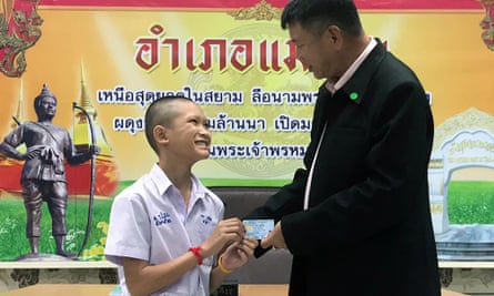 Mongkol Boonpiam receives his Thai ID card from local official Somsak Kanakham.