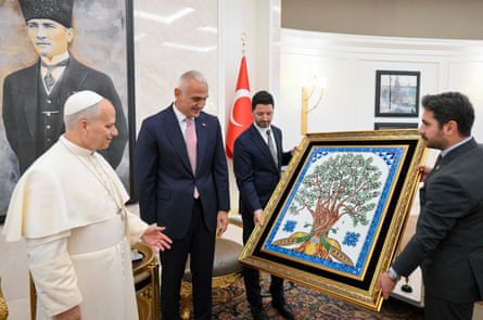 Pope Leo XIV is welcomed by Turkey’s Culture and Tourism minister Mehmet Nuri Ersoy after disembarking from his plane in Ankara.
