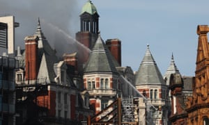 The hotel being hosed with water to get the blaze under control.