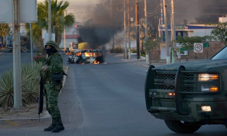 A cargo vehicle in flames after clashes between federal forces and armed groups in the city of Culiacán.