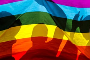 Nairobi, Kenya LGBT refugees are silhouetted through a rainbow flag