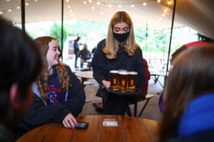 The Fox on the Hill pub reopen as COVID-19 restrictions ease, in LondonA worker brings drinks to customers after The Fox on the Hill pub reopening, as the coronavirus disease (COVID-19) restrictions ease, in London, Britain April 12, 2021. REUTERS/Hannah Mckay