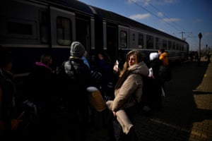 Nastya Savchenko looks on at the platform before boarding a train to Bucharest, with her friends Marina Bozhko, Nadya Pashenko and Tanya Izvekova, after they fled Ukraine amid Russia’s invasion, at Suceava train station, Suceava, 14 March
