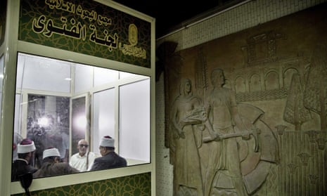 Clerics wait to answer commuters’ questions inside a fatwa kiosk at al-Shohada metro station in Cairo.