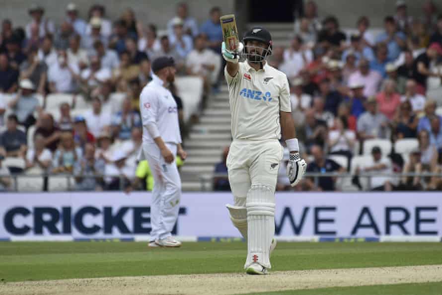 New Zealand’s Daryl Mitchell raises his bat to celebrate scoring fifty runs.