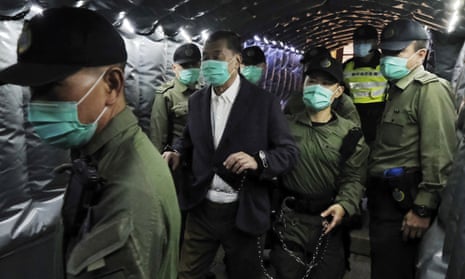 Jimmy Lai is escorted to a prison van on Thursday.