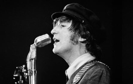 Lennon pictured side-on singing into a microphone