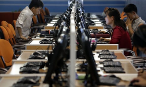 North Korean men and women use computer terminals in Pyongyang.