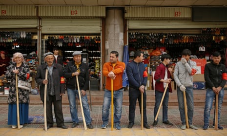Shopkeepers perform daily anti-terror drill outside the bazaar in Kashgar, in March.