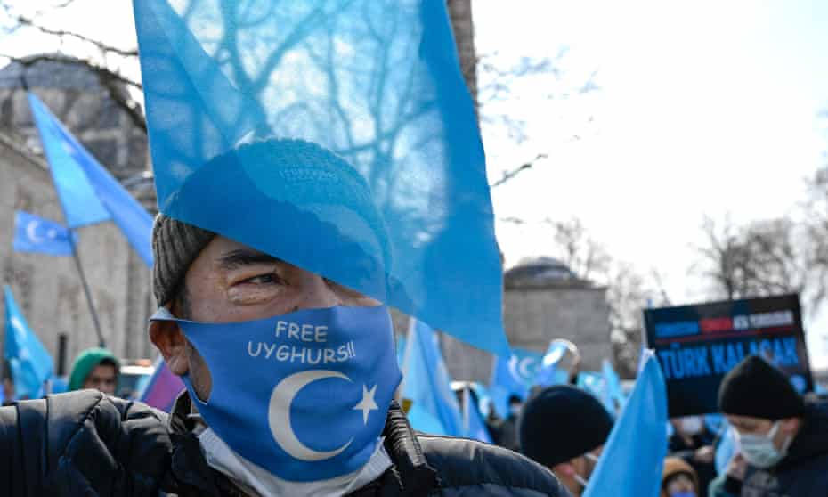 A protester from the Uyghur community living in Turkey, holds an anti-China placard during a protest in Istanbul, on 25 March.