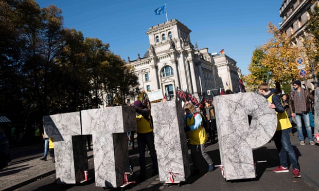 Protesters attend a rally against the proposed US-EU free trade pact in Berlin.