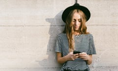 Portrait of fashionable young woman wearing hat using smartphone 