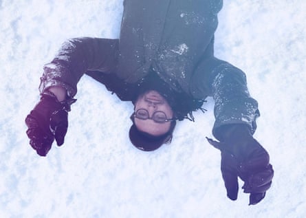 Director Josh Fox lying in the snow in How to Let Go…