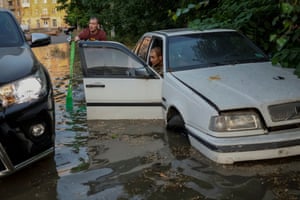 Local residents try to retrieve their car from a flooded street. Russia’s UN envoy was accused of floundering in a “mud of lies” after he claimed at an emergency session of the security council that Ukraine destroyed Kakhovka dam in a “war crime”.