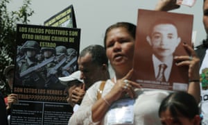 A woman holds a picture of a relative during a 2009 march against the ‘false positives’ scandal. colombia