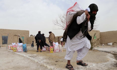 People receive food rations distributed by Afghan Charity Foundation in Kandahar, Afghanistan on 06 February 2022.