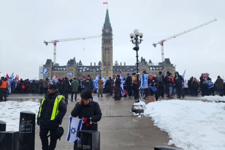 Demonstrators holding Israeli flags at a rally in Ottawa, Canada