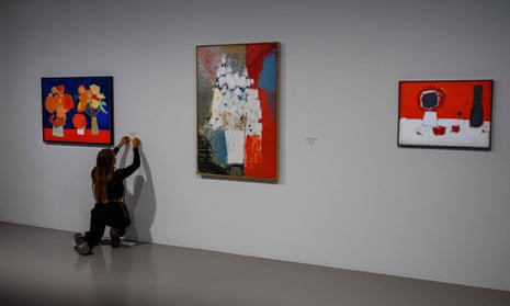 A woman fixes text next to a painting by Nicolas de Staël at the Museum of Modern Art in Paris