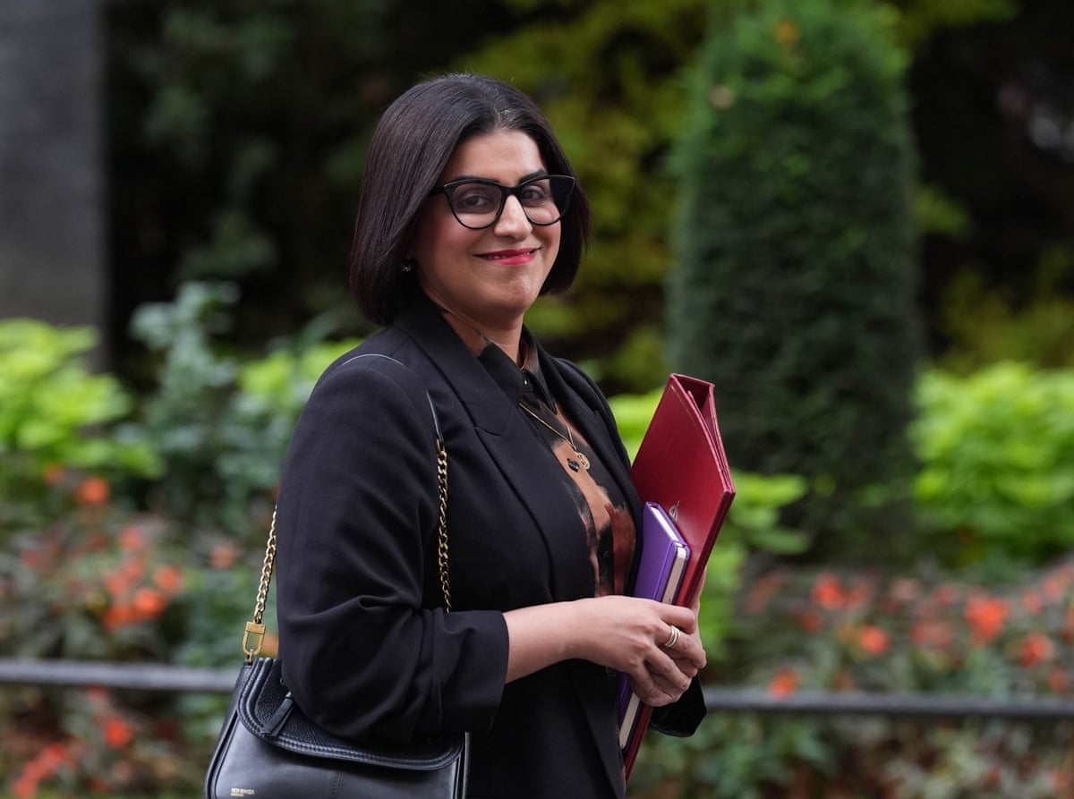 Shabana Mahmood walks in Downing Street with a red folder of documents under her arm.