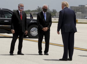 Maskless in Miami. Miami-Dade County Mayor Carlos Gimenez, center, and Commissioner Esteban Bovo, left, welcome Donald Trump earlier today.