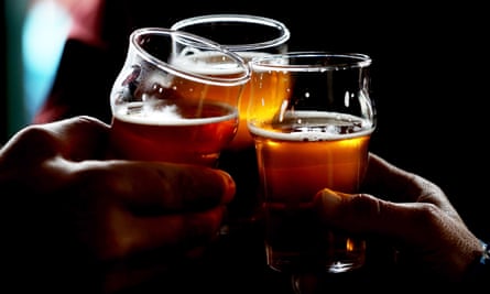 people clinking beer glasses