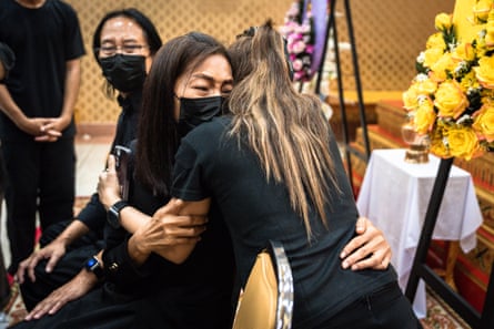 The parents of school shooting victim Naphat Chaima greet wellwishers at her funeral