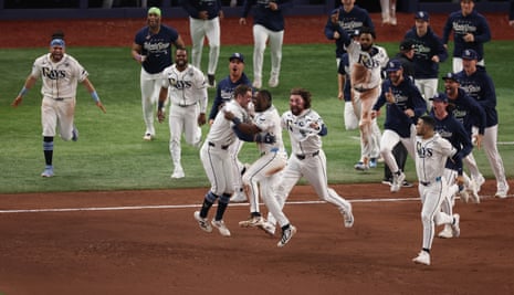 Tampa Bay players mob Ben Williamson after his walk-off RBI single in the 12th inning secured a Game 4 victory over Milwaukee and kept their World Series hopes alive on Tuesday night.