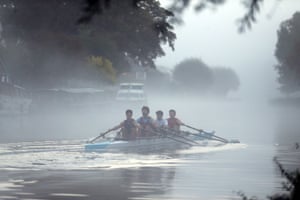 Rowers train in the early morning mist on the river Cam in Cambridge