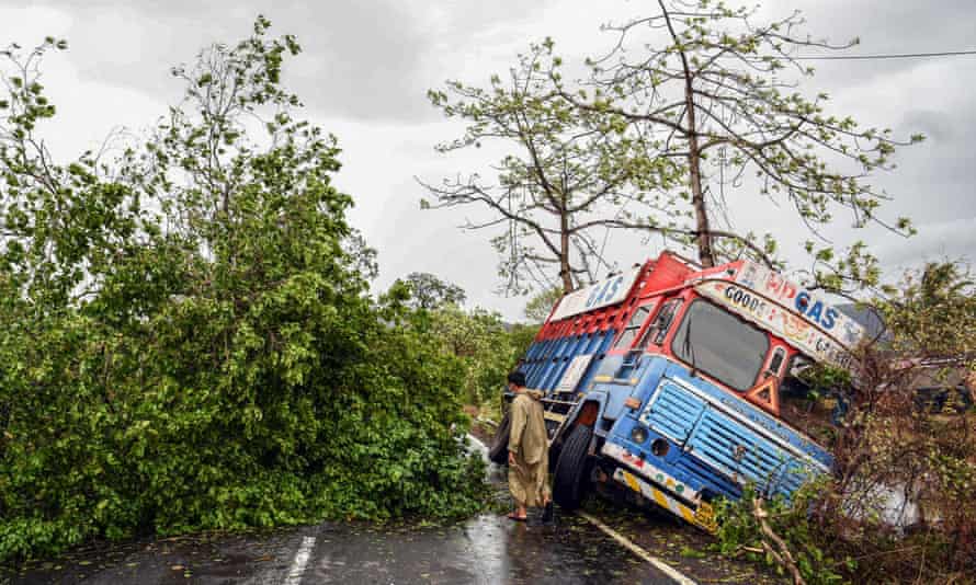 A trunk is seen off the road near uprooted trees that have fallen on a main road in Alibag town of Raigad district, following cyclone Nisarga landfall in India’s western coast.