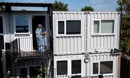 Nasibah Yagoub, 21, with her son outside a shipping container development being used for homeless families in Hanwell, Ealing.