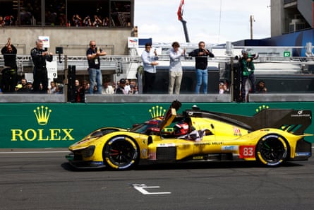 Robert Kubica, in his No 83 privateer Ferrari 499P, celebrates after crossing the finish line to win the Le Mans 24 Hours.