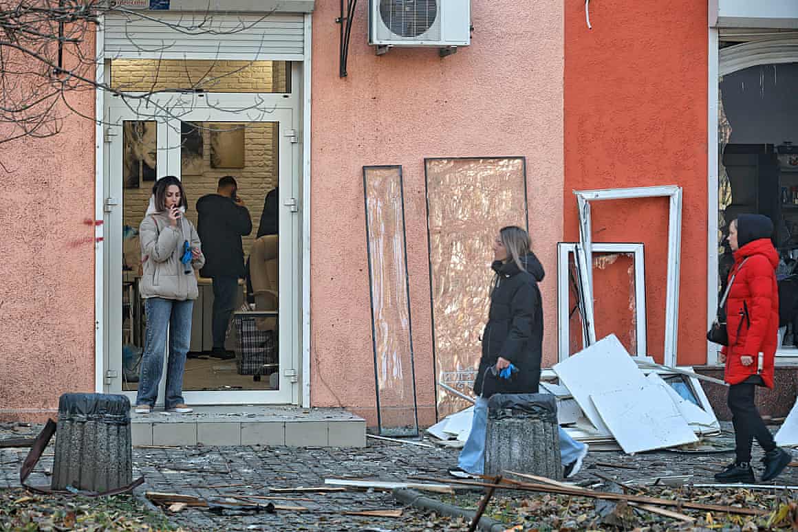 Women walking through debris in a street