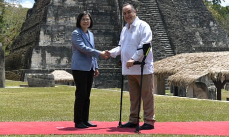 Tsai Ing-wen shakes hands with Alejandro Giammattei on a tour of Maya ruins at Tikal, Guatemala.