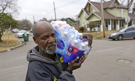 A Houston resident taking bottled water home after winter weather in Texas crippled utilities.