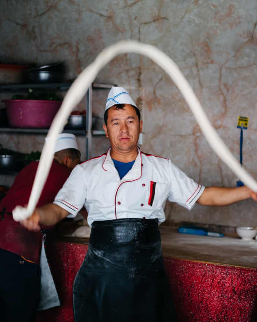 A cook making hand pulled noodles at the bazaar