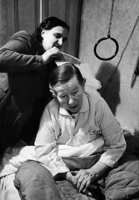 A 1954 Chillingworth photo of a social worker with her elderly client.