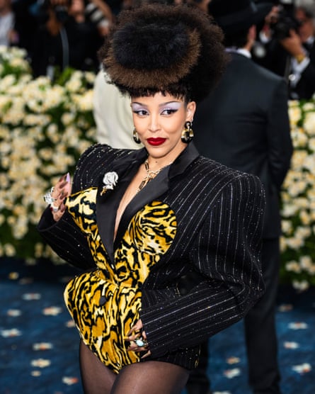 Doja Cat in pinstripe jacket with leopard print detail, wearing pants