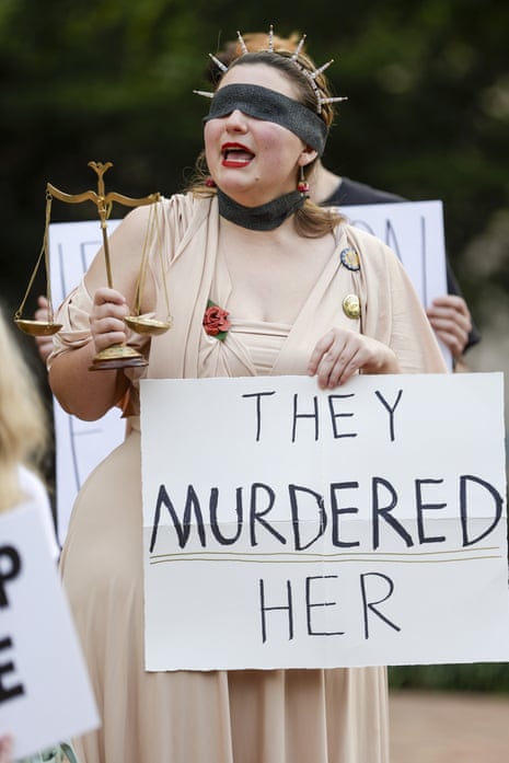 A woman who identified herself as Jessica J. holds up a sign at Tampa City Hall to protest an Immigration and Customs Enforcement shooting that killed a woman in Minneapolis on Thursday, Jan. 8, 2026 in Tampa. Florida News, Tampa, USA - 08 Jan 2026