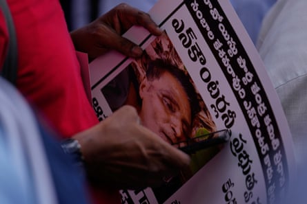 An activist from Left parties holds a placard with the picture of Nambala Keshava Rao, General secretary of the Communist Party of India (Maoist), during a protest against the recent killings of suspected Maoist rebels during an operation by security forces in indian state of Chhattisgarh, in Hyderabad, Thursday, May 22, 2025.