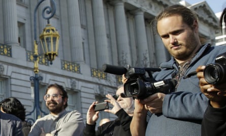 David DePape, right, records the nude wedding of Gypsy Taub outside City Hall on 19 December 2013, in San Francisco.