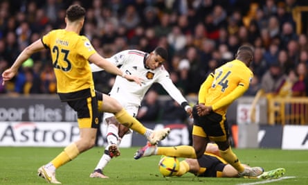 Marcus Rashford drills his shot through a crowd of Wolves players to score for Manchester United