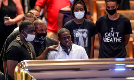 Houston rapper Cal Wayne looks at the casket during a public visitation for George Floyd at the Fountain of Praise church, in Houston, Texas.